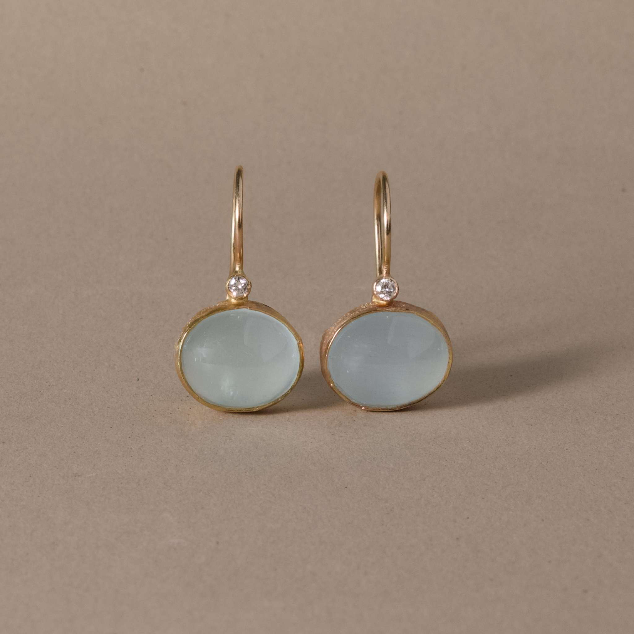 pero  diamond aquamarine earrings with pale blue gemstones in 14k gold setting.