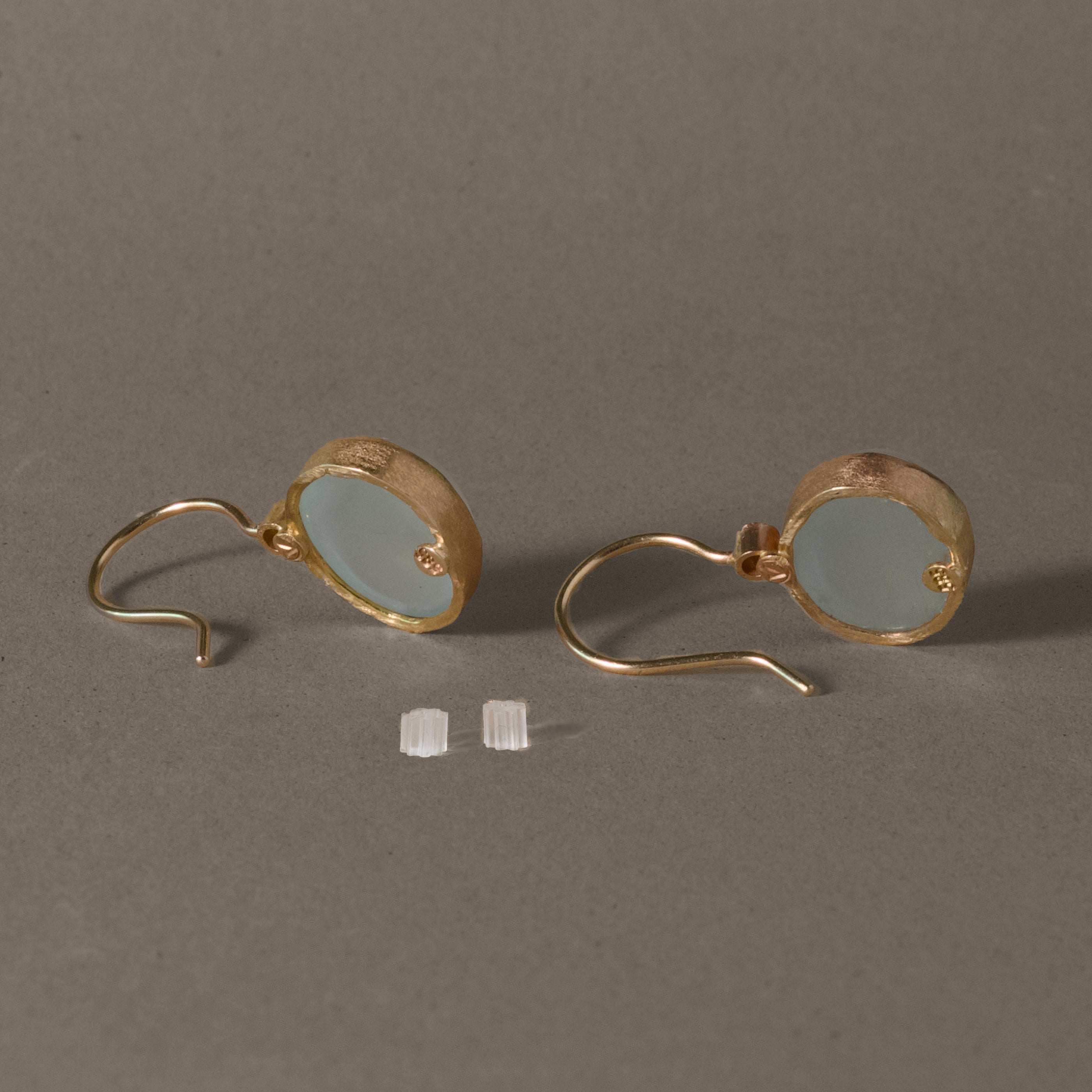 Diamond aquamarine earrings in gold with milky aqua stones and diamond accents.