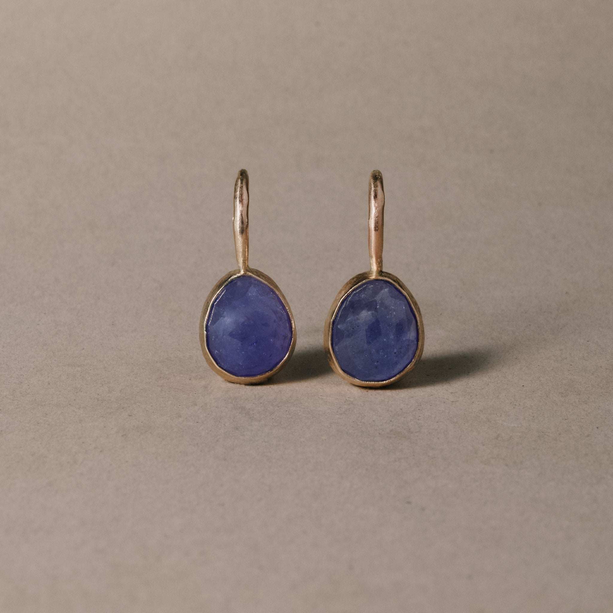 Tanzanite drop earrings with violet blue stones and 14ct gold accents.