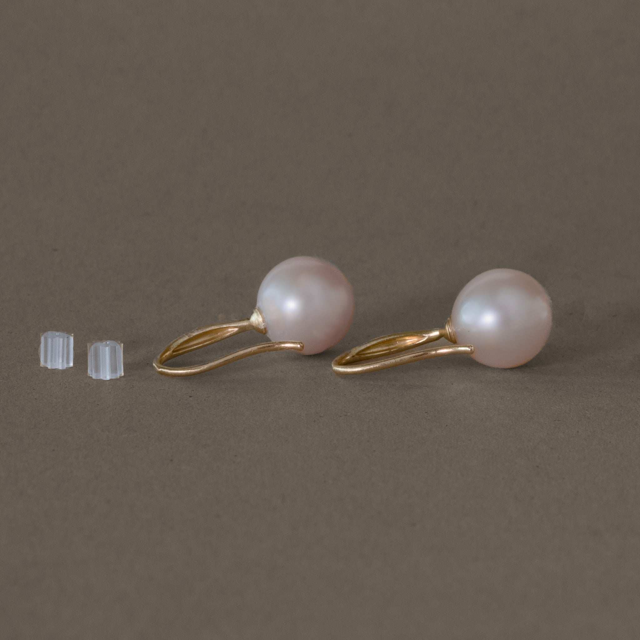 Pink pearl earrings delicately set in gold for a feminine touch.