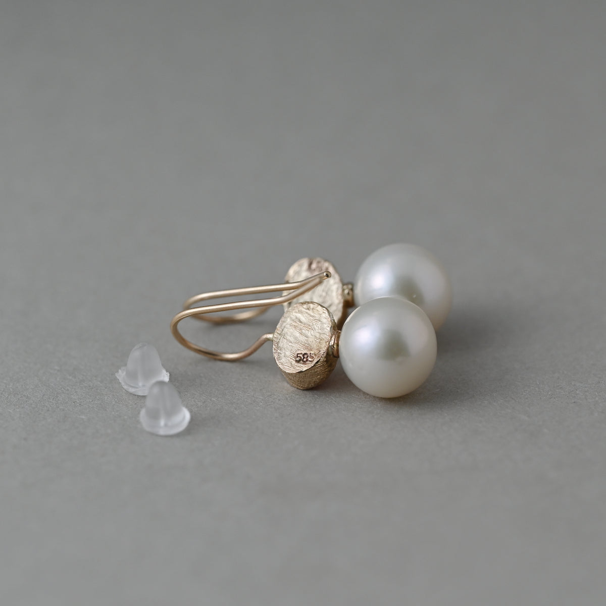 back of pink tourmaline and Edison pearl earrings in solid 14ct gold showing hallmark