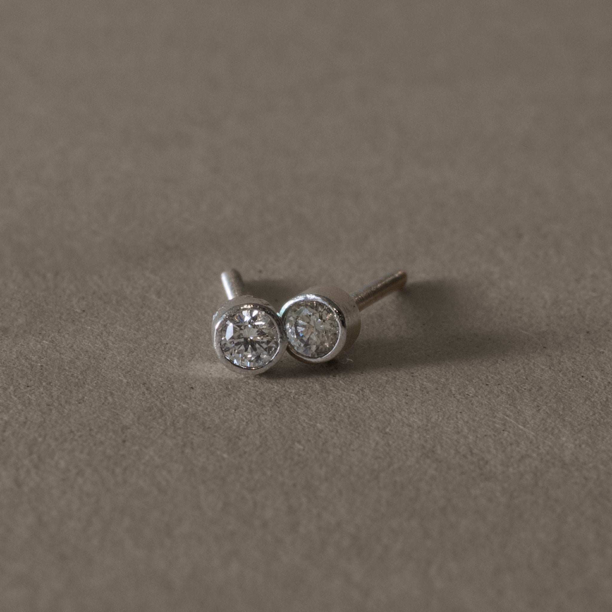 Platinum diamond stud earrings with sparkling gemstones.