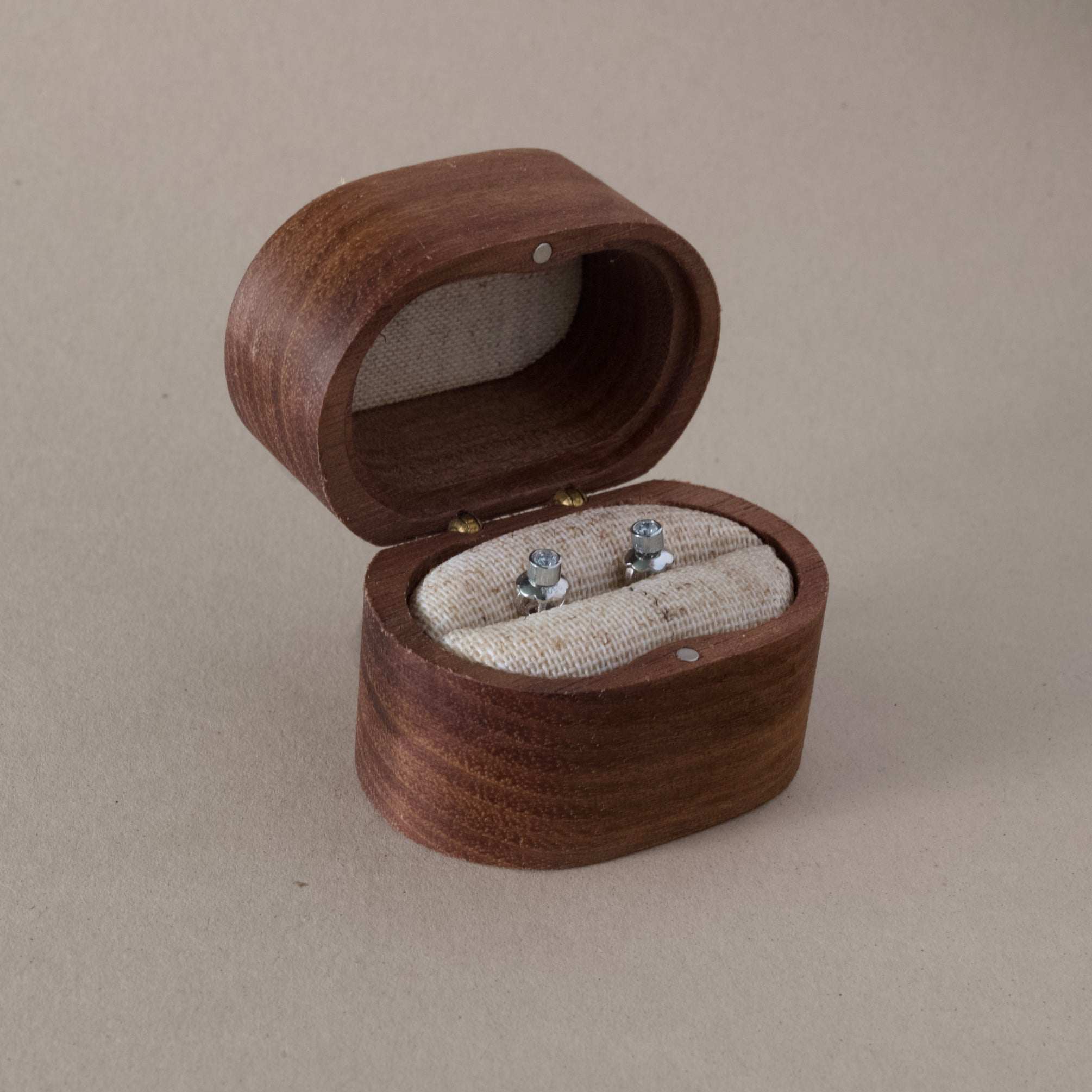 Platinum diamond stud earrings in a wooden box.