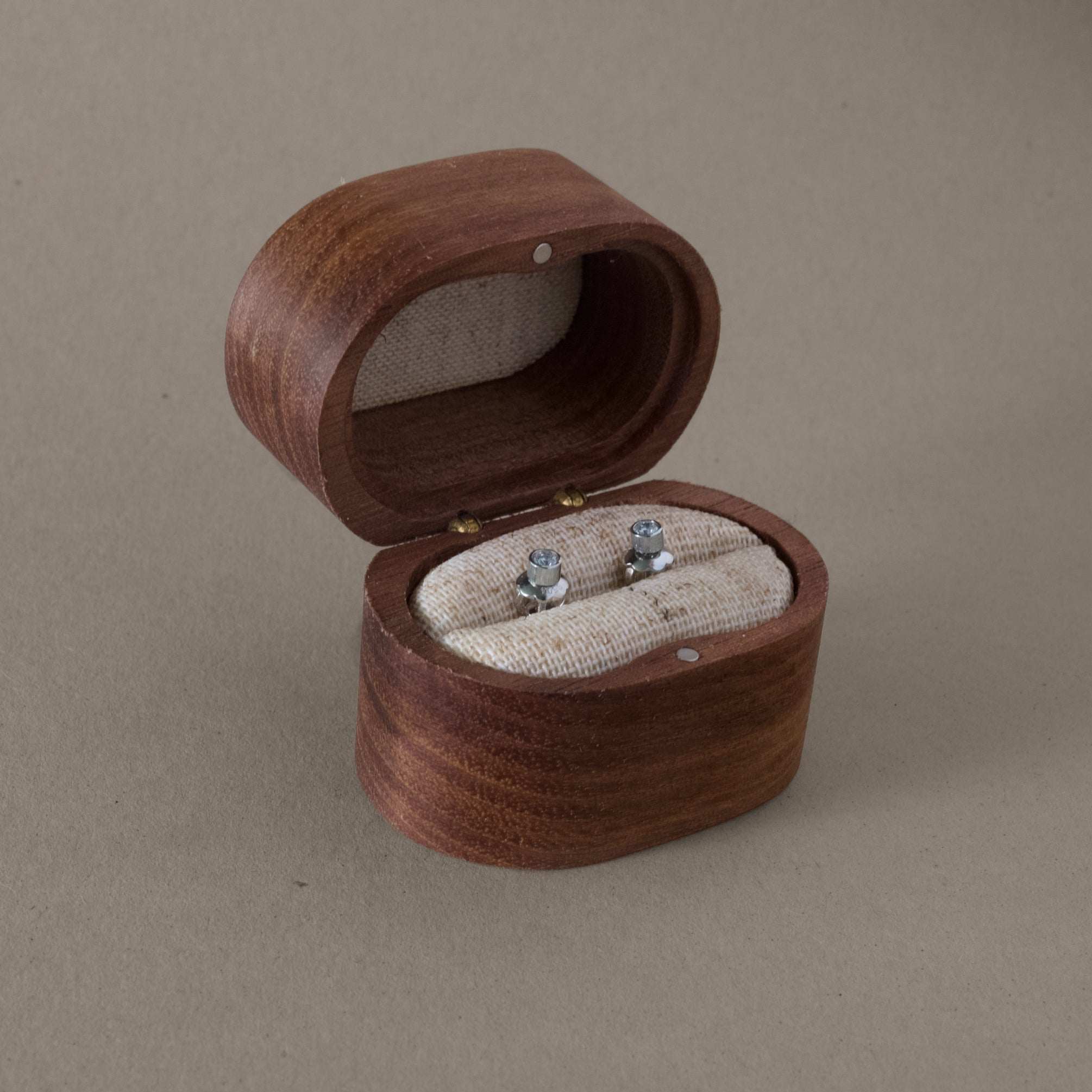 Platinum diamond stud earrings in a wooden box.