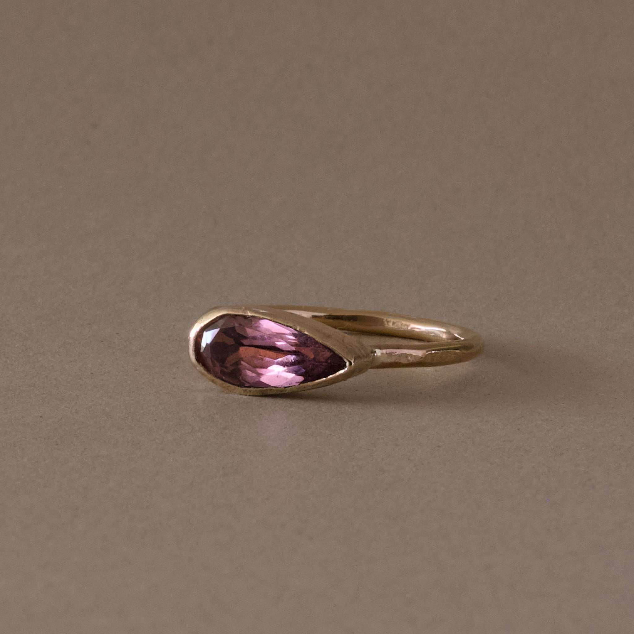 pero rose pink tourmaline ring  on hammered gold band, unique pear shape design.