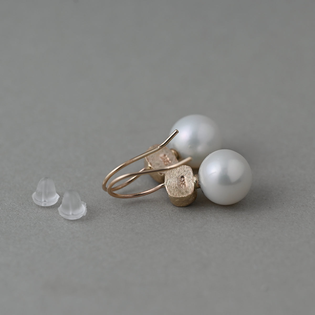 Backs of Santa Maria Aquamarine and Edison freshwater pearl earrings in solid 14ct gold 