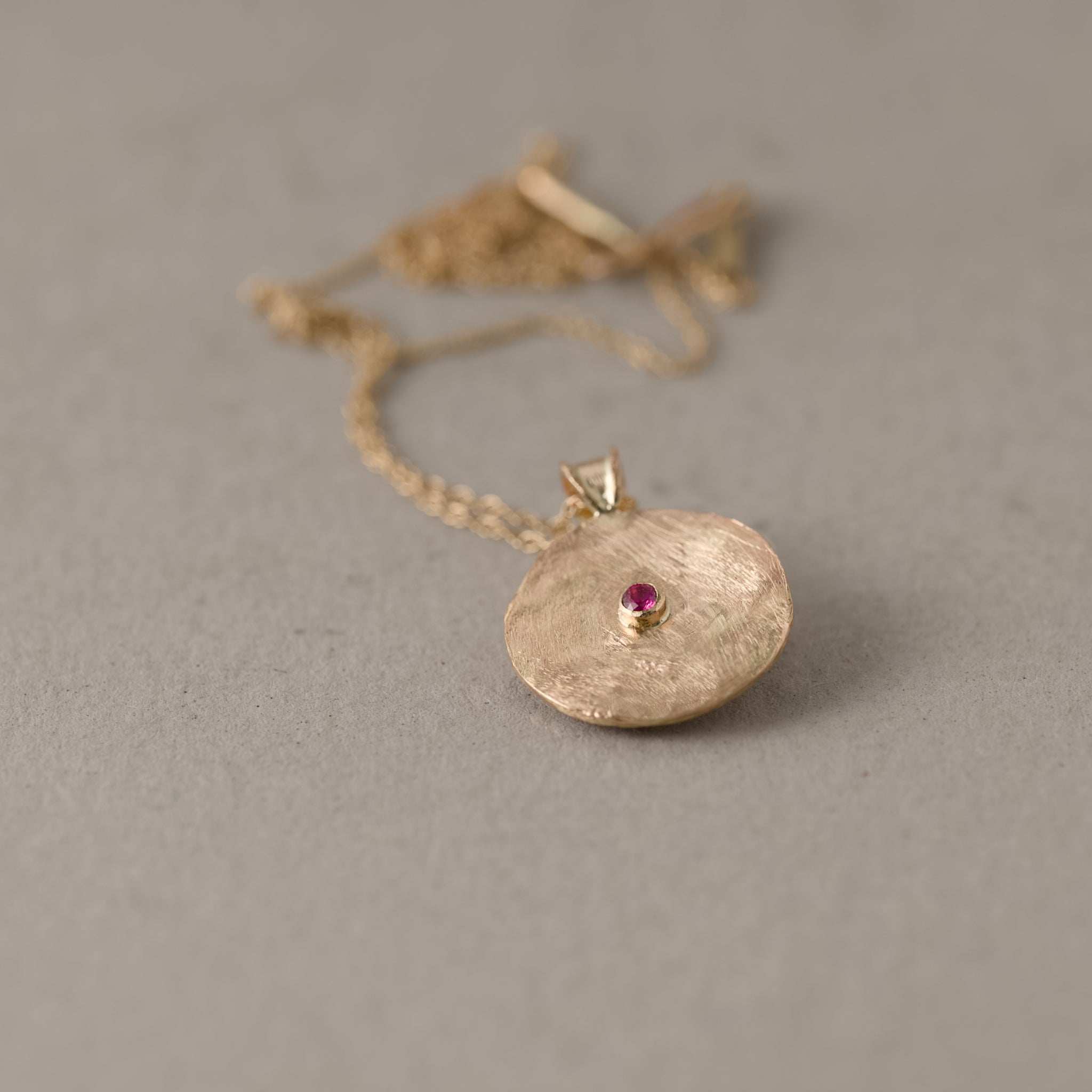 sapphire and rose cut diamond pendant medallion with chain showing the back ruby