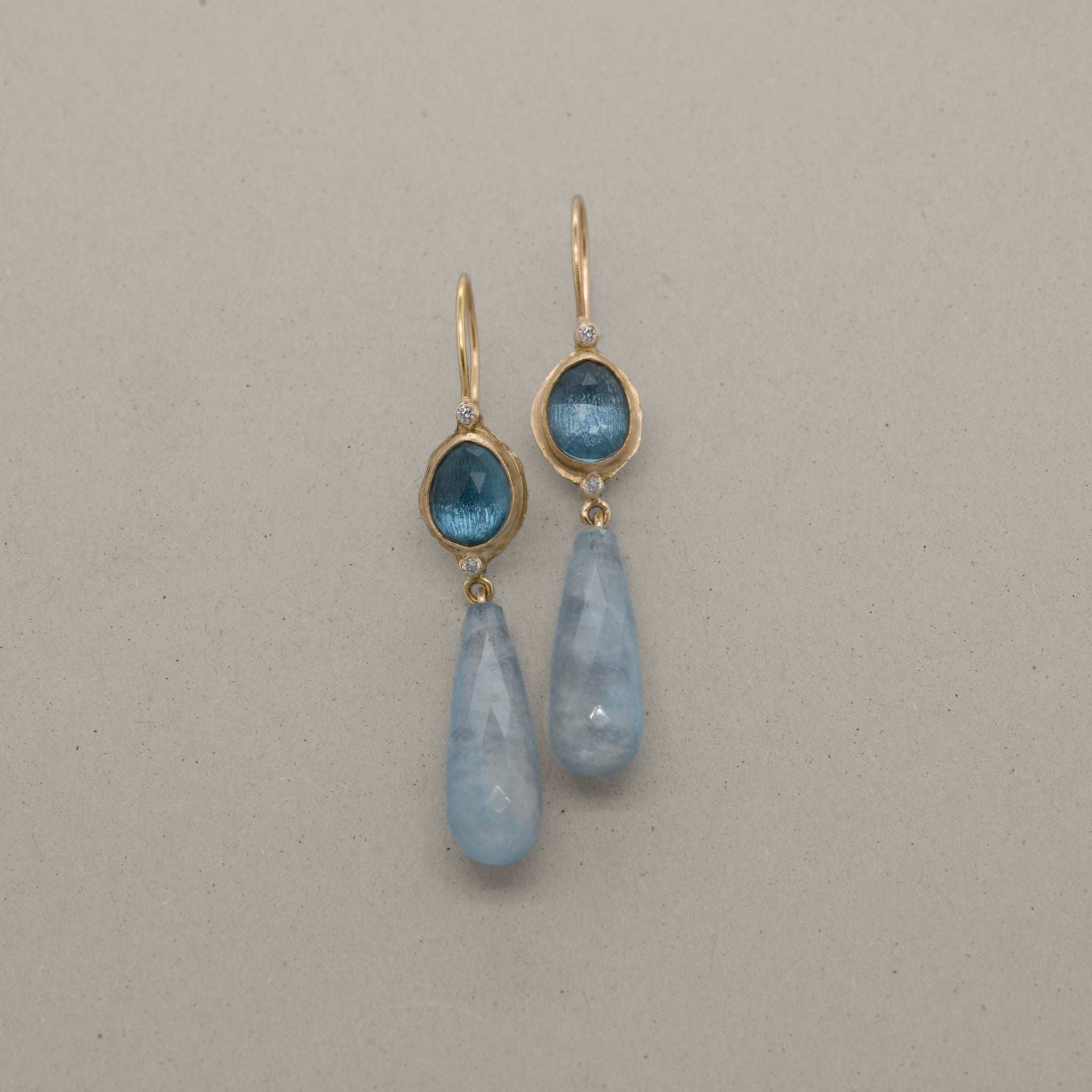 ondon Blue Topaz and Aquamarine drop earrings in hammered 14ct gold with diamond accents, Vermilion Jewellery handcrafted design.