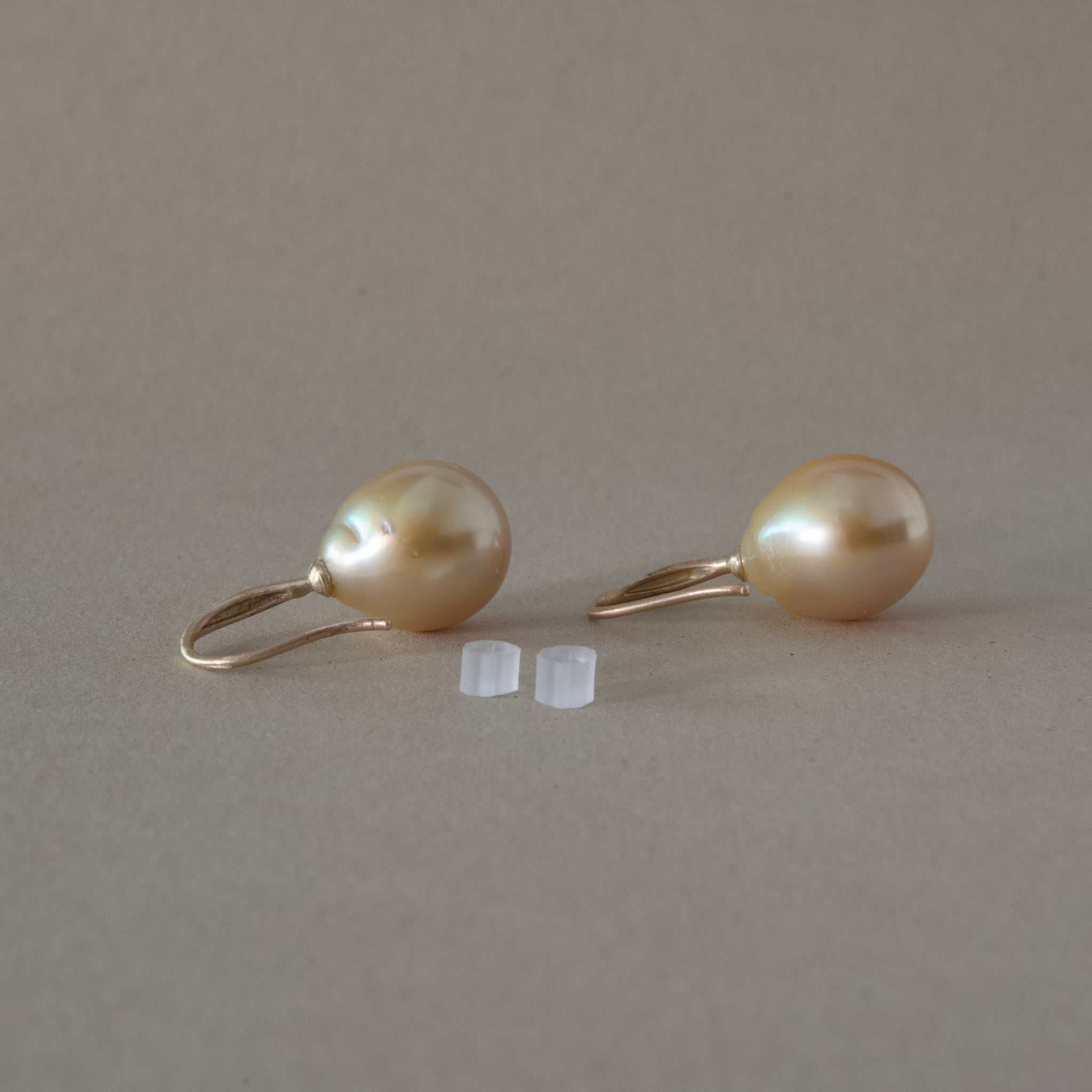 Handmade golden South Sea Pearl Earrings with unique mismatched hues and handcrafted hooks, featuring natural flecks and blemishes.